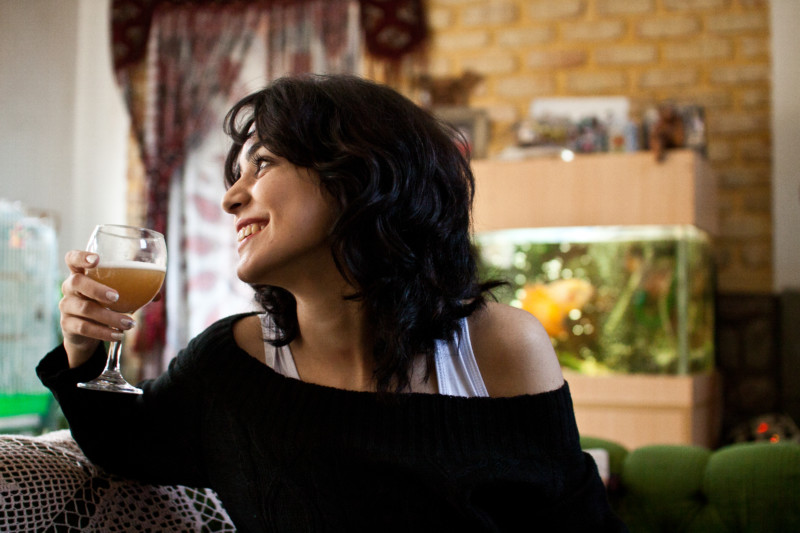 Young woman drinks the home made beer.